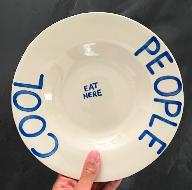 cool people eat here bord in hand